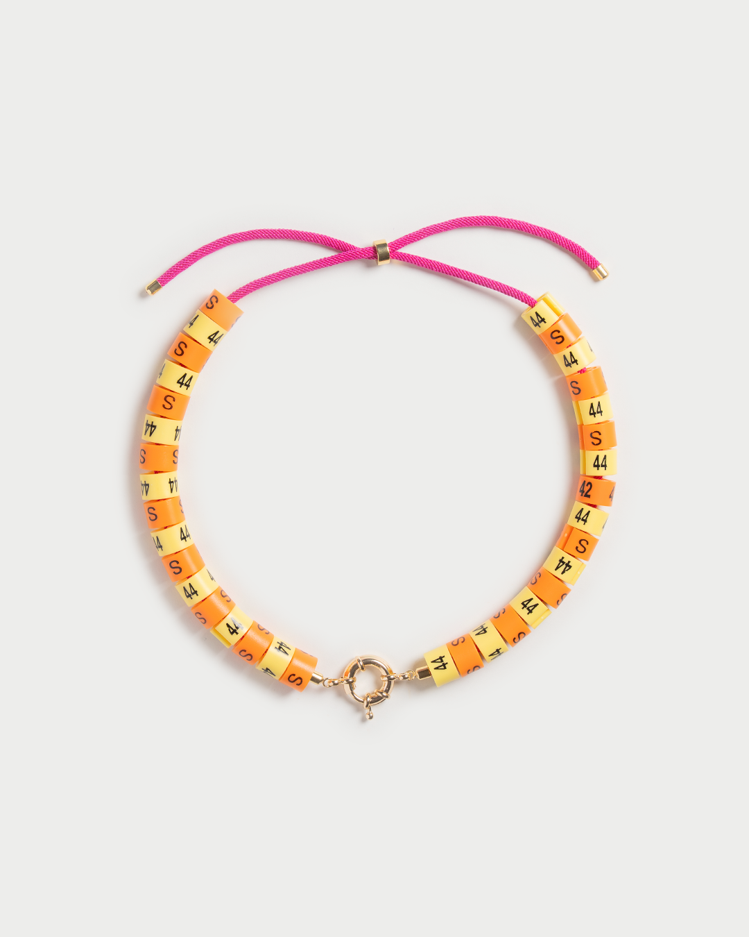 Necklace Raya in colors butter yellow and orange radiate golden hour energy and serenity in a unisex experience