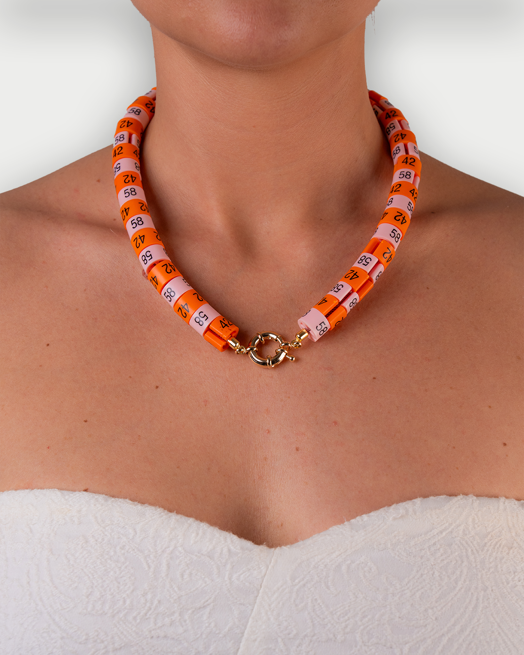 Necklace Soraya with in colors orange and baby pink inspired by the sunset